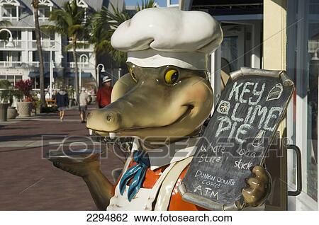 Stock Image - USA, Florida Keys, Animated alligator sign advertising Key Lime Pie; Key West. Fotosearch