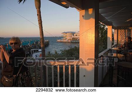 USA, Florida Keys, Middle aged woman watching sunset; Key West View Large Photo Image Stock Image - USA, Florida Keys, Middle aged woman watching sunset; Key West. Fotosearch