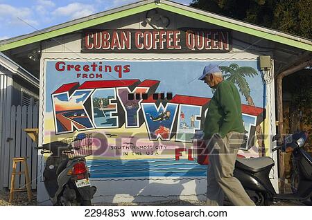 USA, Florida Keys, Old man passing Cuban Coffee Queen shack featuring mural saying greetings from Key West; Key West View Large Photo Image Stock Image - USA, Florida Keys, Old man passing Cuban Coffee Queen shack featuring mural saying greetings from Key West; Key West. Fotosearch