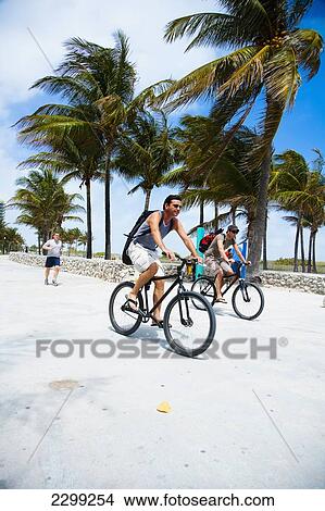 USA., Florida, Miami, Ocean Drive; South Beach, Cyclists on promenade View Large Photo Image Picture - USA., Florida, Miami, Ocean Drive; South Beach, Cyclists on promenade. Fotosearch