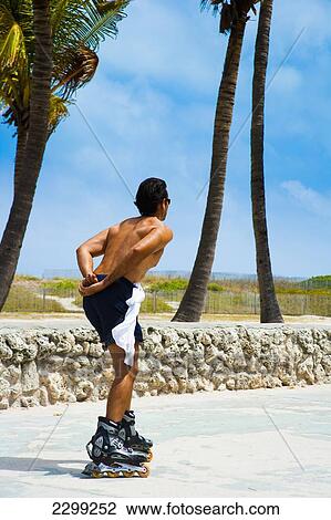 Stock Image - USA., Florida, Miami, Ocean Drive; South Beach, Roller bladder. Fotosearch