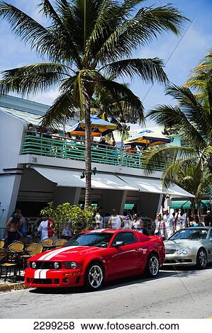 USA., Florida, Miami, Ocean Drive; South Beach, bright red colored Ford Mustang muscle car parked up, All american View Large Photo Image Stock Photo - USA., Florida, Miami, Ocean Drive; South Beach, bright red colored Ford Mustang muscle car parked up, All american. Fotosearch