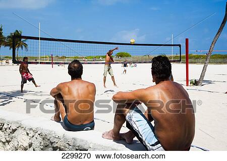 Stock Image - USA., Florida, Miami, Spectators watching beach Volley ball match; South Beach. Fotosearch