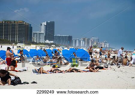 Stock Photo - USA., Florida, Miami, Subathers enjoying their vacation on the beach; South Beach. Fotosearch