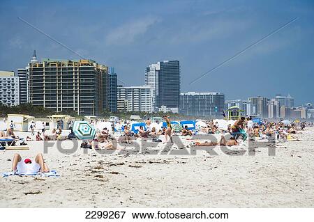 Stock Photo - USA., Florida, Miami, Subathers enjoying their vacation on the beach; South Beach. Fotosearch