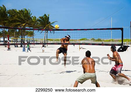 Stock Image - USA., Florida, South Beach; Miami, Beach Volleyball match. Fotosearch