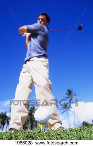 USA, Golfer swinging club at ball on tee; Hawaii Islands View Large Photo Image Stock Photo - USA, Golfer swinging club at ball on tee; Hawaii Islands. Fotosearch