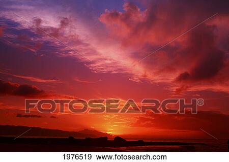 Stock Photo - USA, Hawaii, Beautiful red Sunset; Oahu. Fotosearch