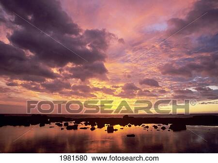 USA, Hawaii, Big Island, Colorful sunset reflecting on still water with Pacific ocean in background; Kona Coast View Large Photo Image Stock Image - USA, Hawaii, Big Island, Colorful sunset reflecting on still water with Pacific ocean in background; Kona Coast. Fotosearch