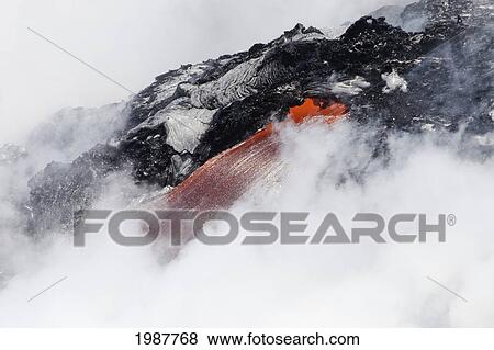 Stock Photo - USA, Hawaii, Big Island, Steam cloud nearly hiding red hot lava flow pouring into Pacific Ocean; Hawaii Volcanoes National Park. Fotosearch
