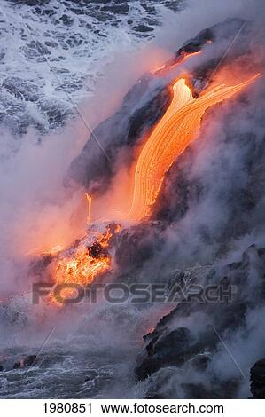 Stock Image - USA, Hawaii, Big Island, View of Pahoehoe lava flowing into Pacific Ocean; Kalapana. Fotosearch