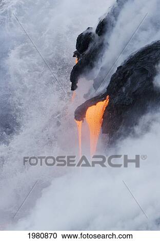Stock Image - USA, Hawaii, Big Island, View of Pahoehoe lava flowing into Pacific Ocean; Kalapana. Fotosearch