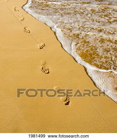 Stock Photo - USA, Hawaii, Footprints on sand along Pacific Ocean in Oneloa or Big Beach in Makena State Park; Maui. Fotosearch