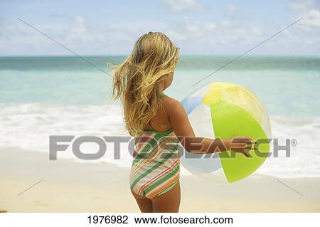 USA, Hawaii, Girl Posing On Beach With Beach Ball; Oahu View Large Photo Image Stock Image - USA, Hawaii, Girl Posing On Beach With Beach Ball; Oahu. Fotosearch