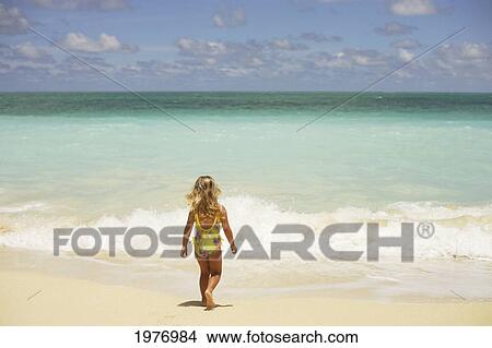 Picture - USA, Hawaii, Girl Walking Away On Beach; Oahu. Fotosearch