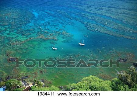Stock Image - USA, Hawaii Islands, Big Island, Two scuba diving boats anchored offshore among reefs; Kohala Coast. Fotosearch
