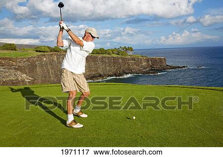 USA, Hawaii Islands, Lanai, Man Playing Golf Near Ocean; Manele Golf Resort View Large Photo Image Stock Photo - USA, Hawaii Islands, Lanai, Man Playing Golf Near Ocean; Manele Golf Resort. Fotosearch