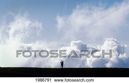 USA, Hawaii Islands, Maui, Couple looking down on giant clouds; Haleakala Crater National Park View Large Photo Image Stock Image - USA, Hawaii Islands, Maui, Couple looking down on giant clouds; Haleakala Crater National Park. Fotosearch