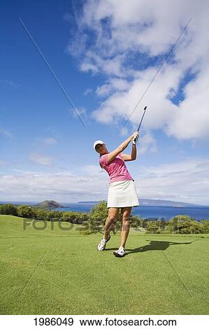 USA, Hawaii Islands, Maui, Female golfer swinging golf club; Wailea Gold Golf Course View Large Photo Image Stock Photo - USA, Hawaii Islands, Maui, Female golfer swinging golf club; Wailea Gold Golf Course. Fotosearch