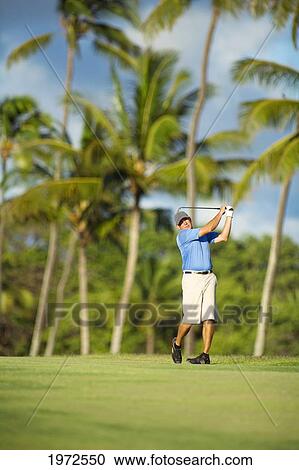 Stock Image - USA, Hawaii Islands, Maui, Man Enjoys Day Of Golf During His Vacation; Maui Country Club. Fotosearch