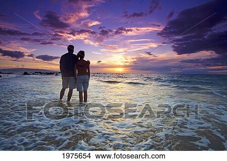USA, Hawaii Islands, Maui, Mokapu Beach; Wailea, Couple Watching Sunset While Wading In Ocean View Large Photo Image Picture - USA, Hawaii Islands, Maui, Mokapu Beach; Wailea, Couple Watching Sunset While Wading In Ocean. Fotosearch