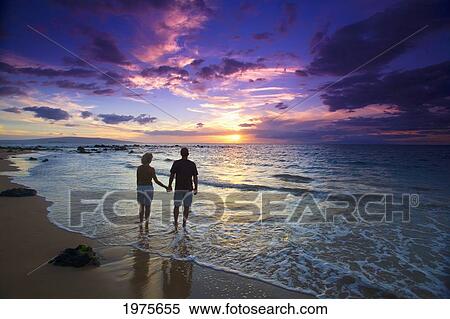 Stock Photography - USA, Hawaii Islands, Maui, Mokapu Beach; Wailea, Silhouetted Couple Watching Sunset. Fotosearch