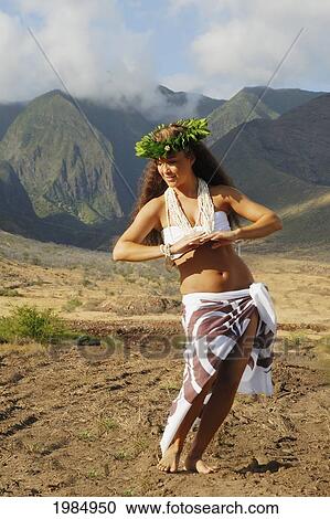 USA, Hawaii Islands, Maui, Mountains in background; West Maui, Beautiful Hawaiian girl dancing hula View Large Photo Image Stock Image - USA, Hawaii Islands, Maui, Mountains in background; West Maui, Beautiful Hawaiian girl dancing hula. Fotosearch
