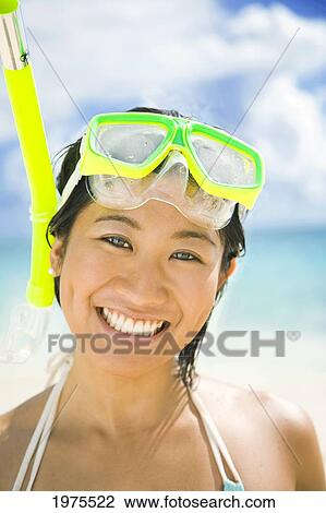 Stock Image - USA, Hawaii Islands, Oahu, Young Woman Wearing Snorkel Gear On Beach; Lanikai. Fotosearch
