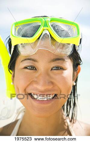 Stock Image - USA, Hawaii Islands, Oahu, Young Woman Wearing Snorkel Gear On Beach; Lanikai. Fotosearch
