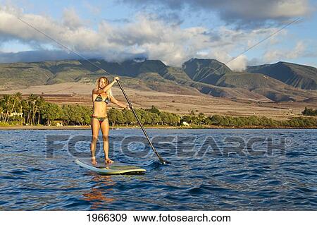 USA, Hawaii Islands, Warm Sunlight; Maui, Woman Stand Up Paddling In Ocean Just Off Canoe Beach View Large Photo Image Stock Photo - USA, Hawaii Islands, Warm Sunlight; Maui, Woman Stand Up Paddling In Ocean Just Off Canoe Beach. Fotosearch