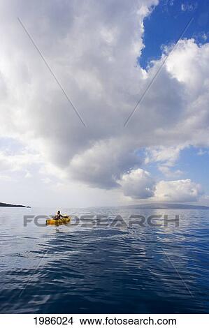 Picture - USA, Hawaii Islands, Woman in yellow kayak on calm ocean of southern coast; Maui. Fotosearch