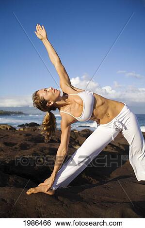 USA, Hawaii Islands, Young woman doing yoga next to ocean; Maui View Large Photo Image Stock Photograph - USA, Hawaii Islands, Young woman doing yoga next to ocean; Maui. Fotosearch