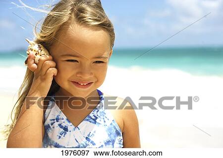 USA, Hawaii, Little Girl Holding Seashell Along Waters Edge; Oahu View Large Photo Image Stock Photo - USA, Hawaii, Little Girl Holding Seashell Along Waters Edge; Oahu. Fotosearch