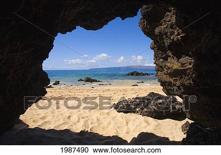 Stock Image - USA, Hawaii, Maui, View from Secret Beach of Kahoolawe from inside of Lavatube Cavern; Makena. Fotosearch