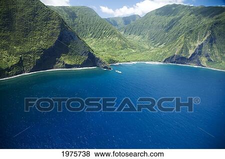 Stock Photo - USA, Hawaii, Molokai, Beautiful green cliffs and sea; North Shore. Fotosearch