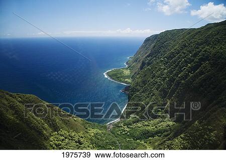Stock Photo - USA, Hawaii, Molokai, Beautiful green cliffs and sea; North Shore. Fotosearch