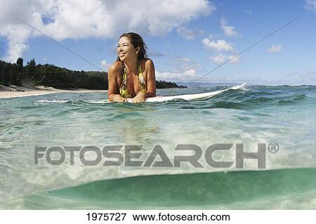 Stock Photo - USA, Hawaii, Oahu, Beautiful Surfer Woman In The Ocean; Waikiki. Fotosearch