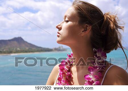 USA, Hawaii, Oahu, Diamond Head in background; Waikiki, Beautiful woman with eyes closed wearing Orchid Lei View Large Photo Image Stock Image - USA, Hawaii, Oahu, Diamond Head in background; Waikiki, Beautiful woman with eyes closed wearing Orchid Lei. Fotosearch