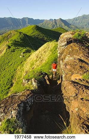 Stock Photo - USA, Hawaii, Oahu, East Oahu, Lanikai, Woman hiking; Kailua. Fotosearch