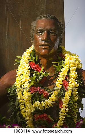 Picture - USA, Hawaii, Oahu, Honolulu, Duke Kahanamoku Statue with flowers; Waikiki. Fotosearch