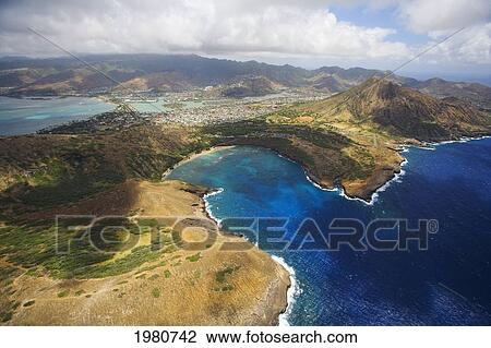 Stock Image - USA, Hawaii, Oahu, Koko Head crater in background; Hawaii Kai, Aerial view of Hanauma Bay and coastline. Fotosearch