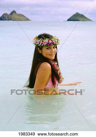 Stock Photo - USA, Hawaii, Oahu, Portrait of Hawaiian girl in Haku and Lei in Pacific ocean; Lanikai. Fotosearch