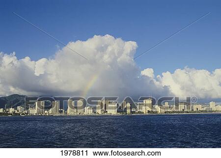 Stock Image - USA, Hawaii, Oahu, Rainbow over Waikiki; Honolulu. Fotosearch