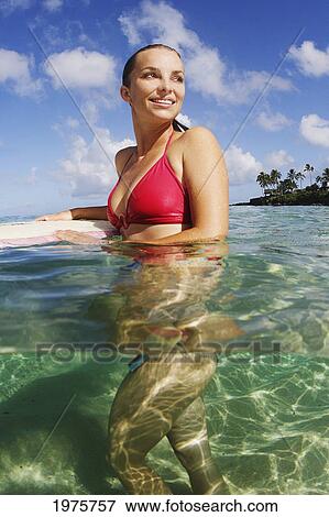 Stock Photo - USA, Hawaii, Oahu, Waikiki, Beautiful Surfer Woman In Ocean; North Shore. Fotosearch