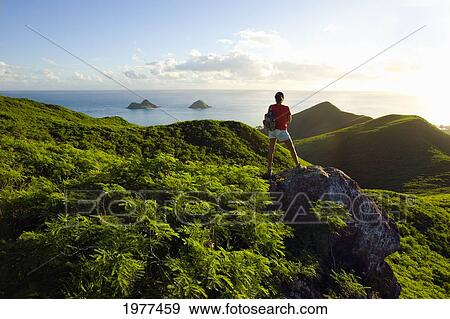 Stock Photo - USA, Hawaii, Oahu, Woman hiker admiring view of Mokulua Islands; Lanikai. Fotosearch