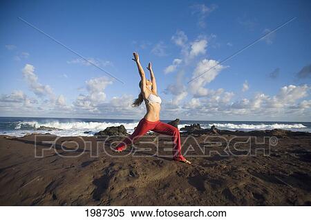 Stock Photography - USA, Hawaii, Young woman doing yoga next to ocean; Maui. Fotosearch