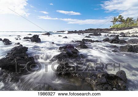 USA, Hawaiian Islands, Big Island, South Kohala, Blur of water pouring around Lava Rocks; Kukio Beach View Large Photo Image Stock Photo - USA, Hawaiian Islands, Big Island, South Kohala, Blur of water pouring around Lava Rocks; Kukio Beach. Fotosearch