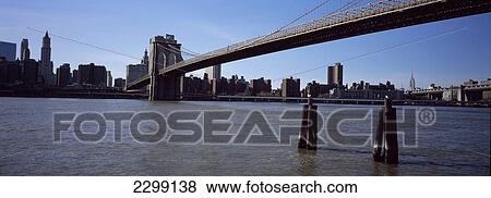 Stock Photo - Usa, Looking Towards Midtown Manhattan And Empire State Building; New York City, Panoramic Shot Of Brooklyn Bridge. Fotosearch