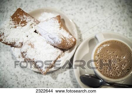 Picture - USA, Louisiana, French Quarter; New Orleans, Pastry with icing sugar and cup of coffee. Fotosearch