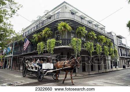 Stock Image - USA, Louisiana, French Quarter; New Orleans, Tourist in horse carriage. Fotosearch